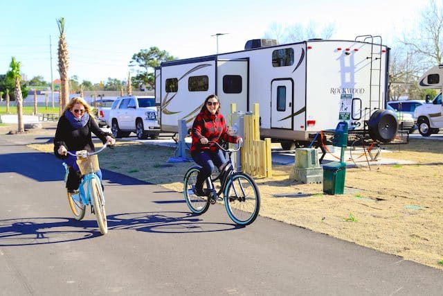 Two ladies cycling around the camp