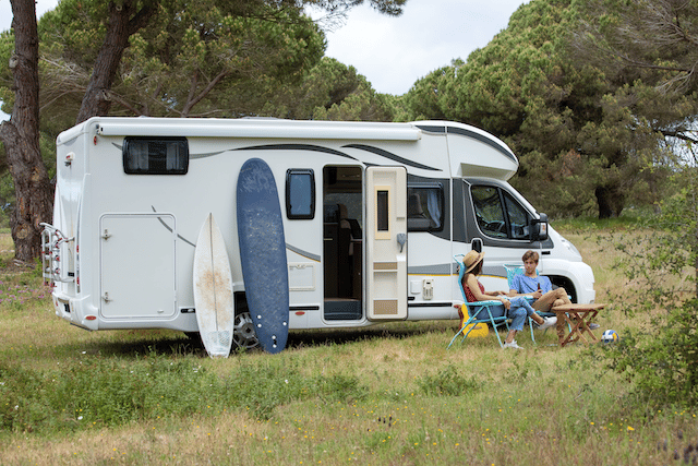 Two RV owners beside their RV