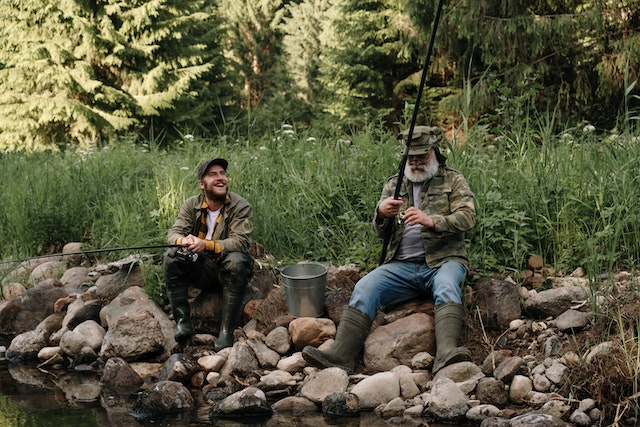 Two men fishing near a river