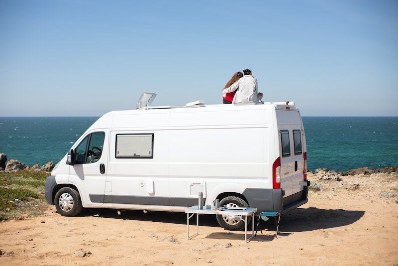 A couple on top their RV