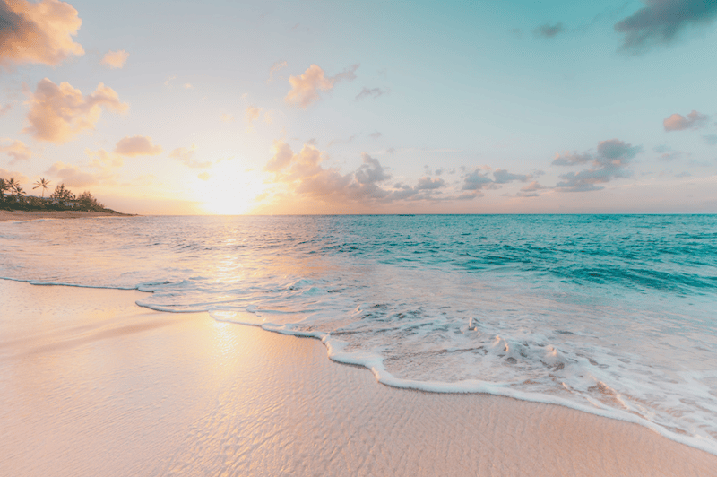 Blue colored sea water touching the beach