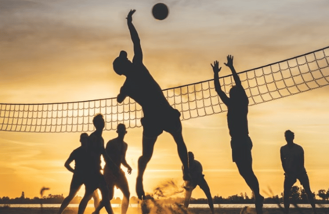 A group of people playing volleyball 