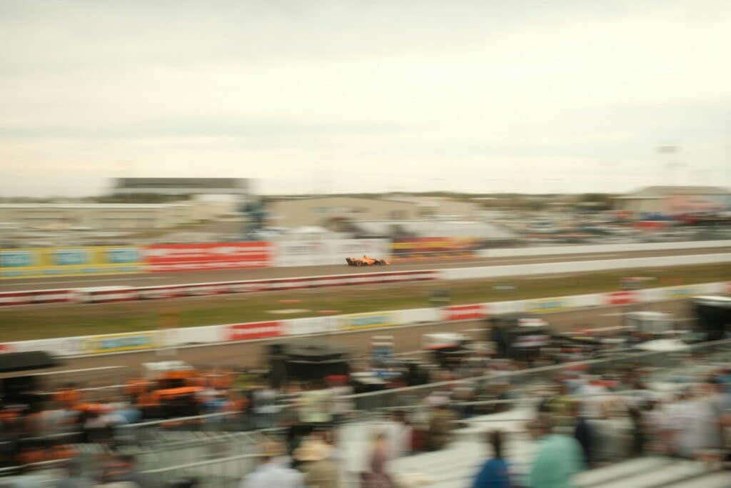 A race car is speeding around the racetrack.