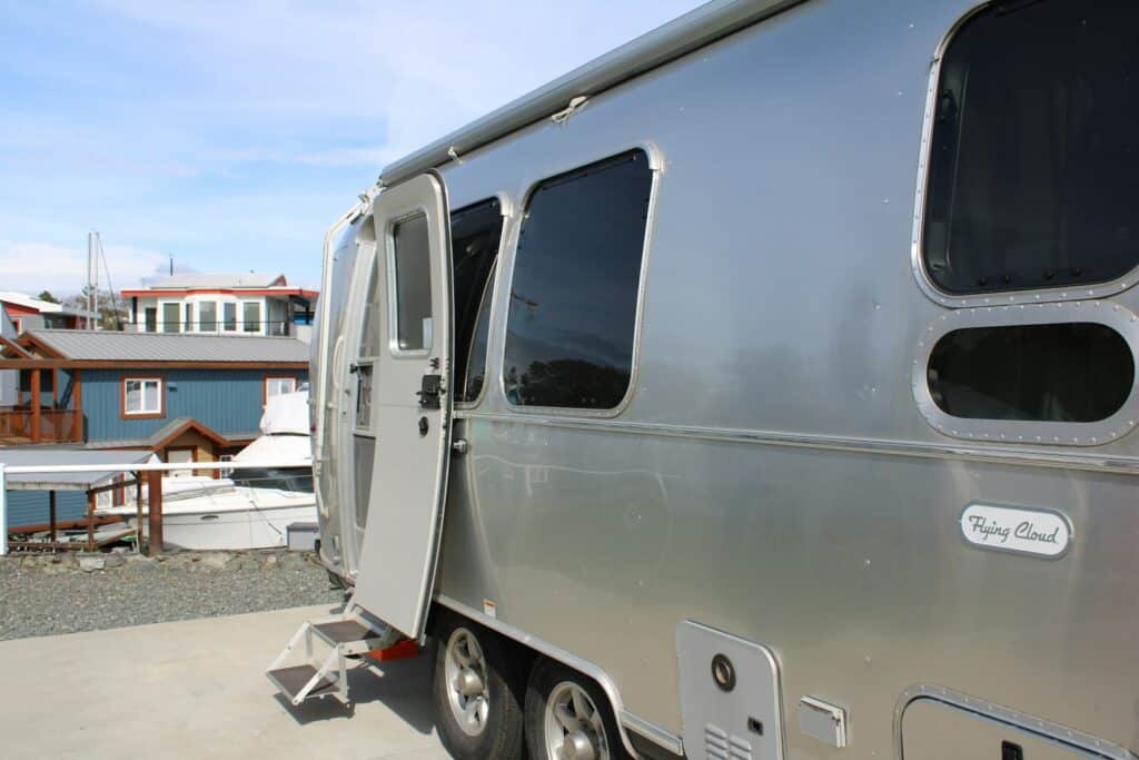 A silver trailer parked on top of a roof