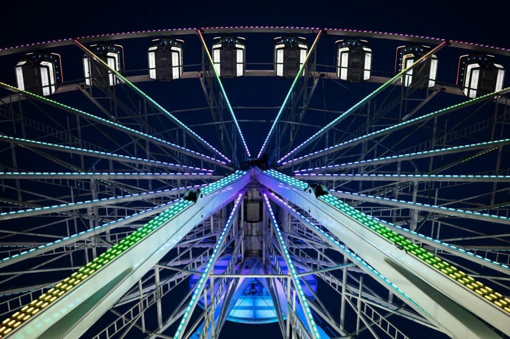 A large ferris wheel lit up at night