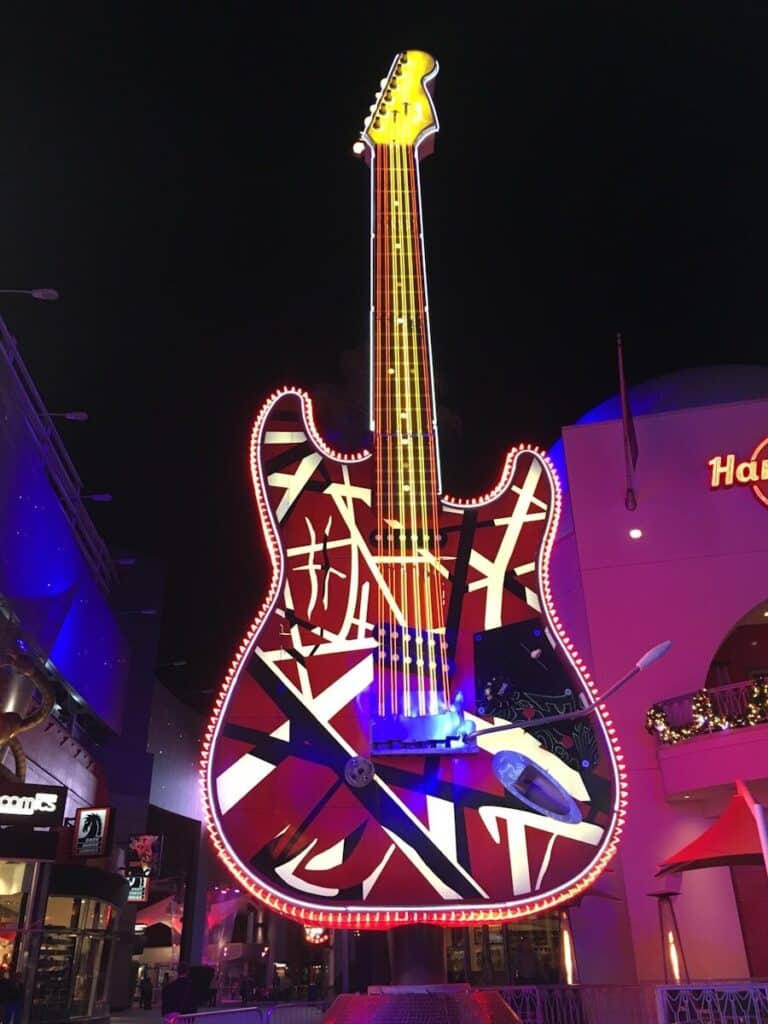 a giant guitar sign in front of a building