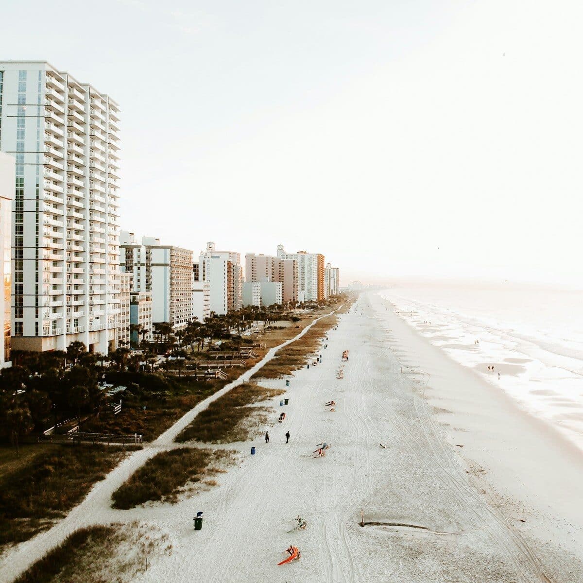 bird's-eye view of beach line The Strand Myrtle Beach vs Cozy Turtle RV Rentals: Which is Right for Your Family Vacation?