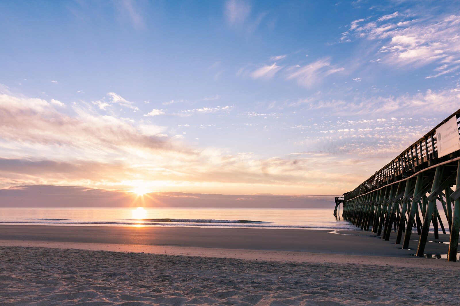 silhouette photography of black wooden dock near shoreline during sunrise What to Do in Myrtle Beach This Fall: Seasonal Events, Outdoor Fun and Hidden Gems