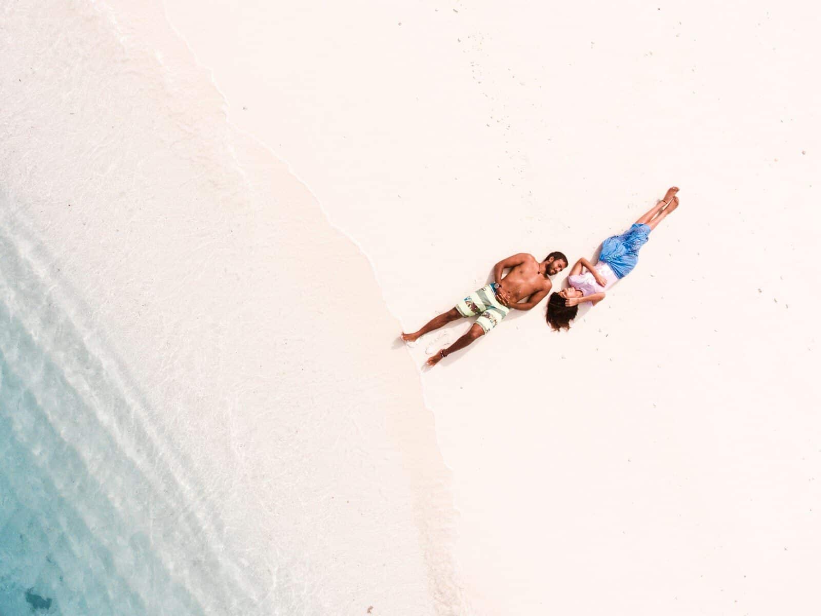 bird's eye view of man and woman lying on shore Couple Vacation Ideas | Your Guide to a Truly Memorable Escape in Myrtle Beach