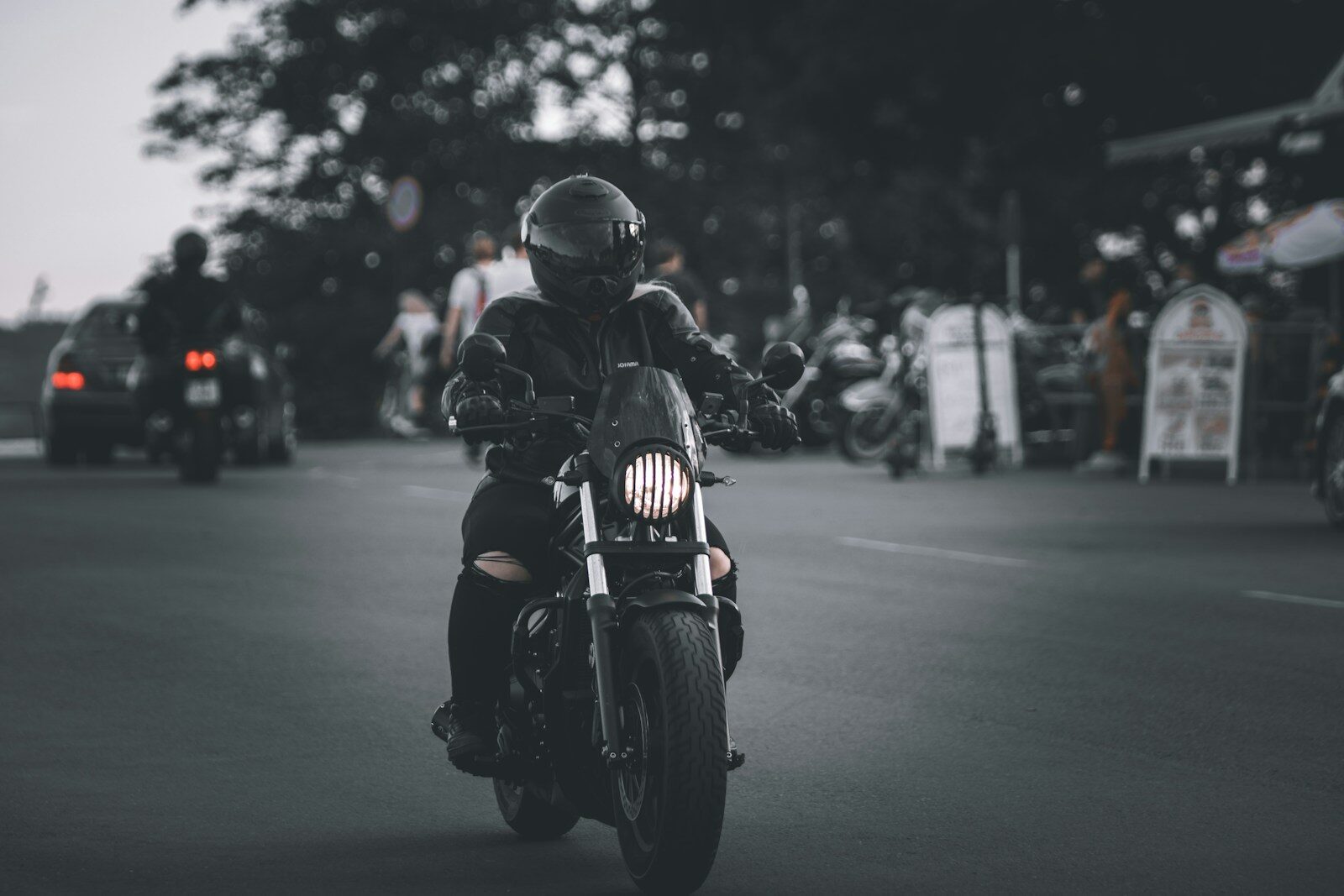 Photo by Nihon Graphy man in black motorcycle helmet riding motorcycle on road during daytime