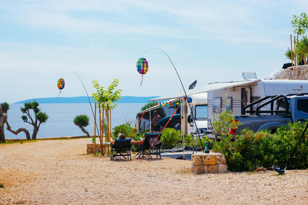 Dreamy Snowbird Rentals | Escape the Winter Blues 11 Relaxing RV camping with vibrant lanterns and sea view in Novalja, Croatia.