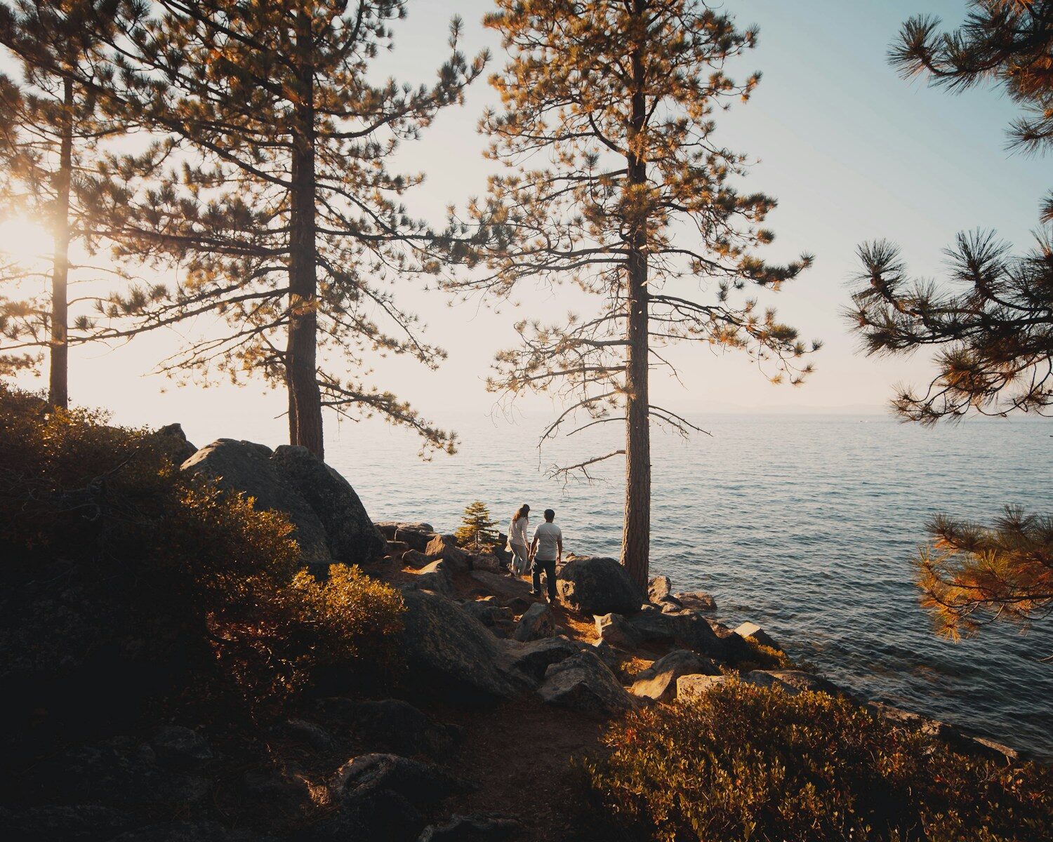 Photo by Ephraim Mayrena person sitting on rock near body of water during daytime