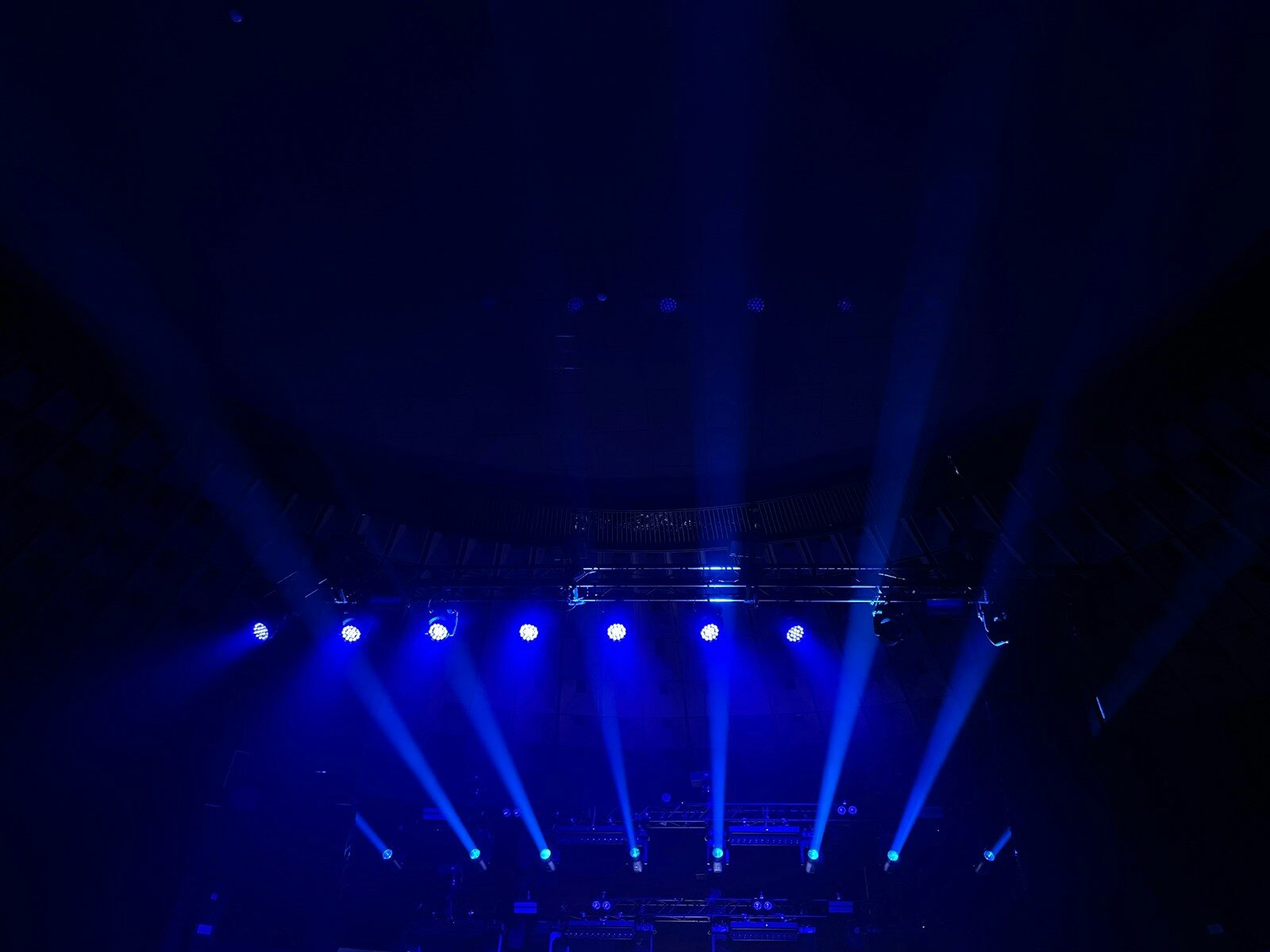 A group of people on a stage with blue lights