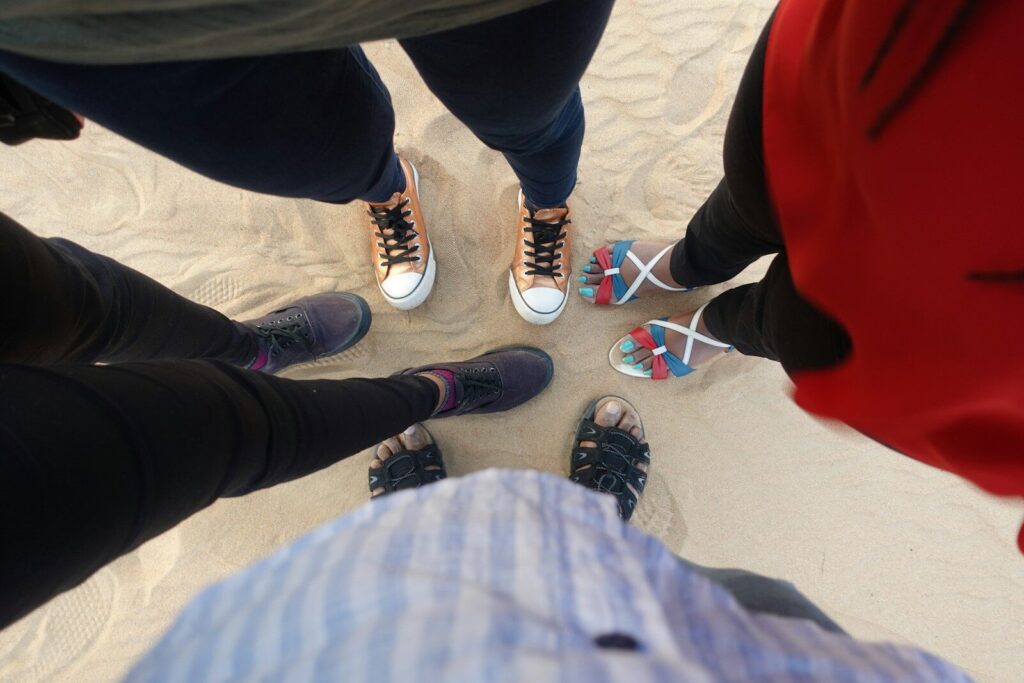 person in black pants and black and white sneakers