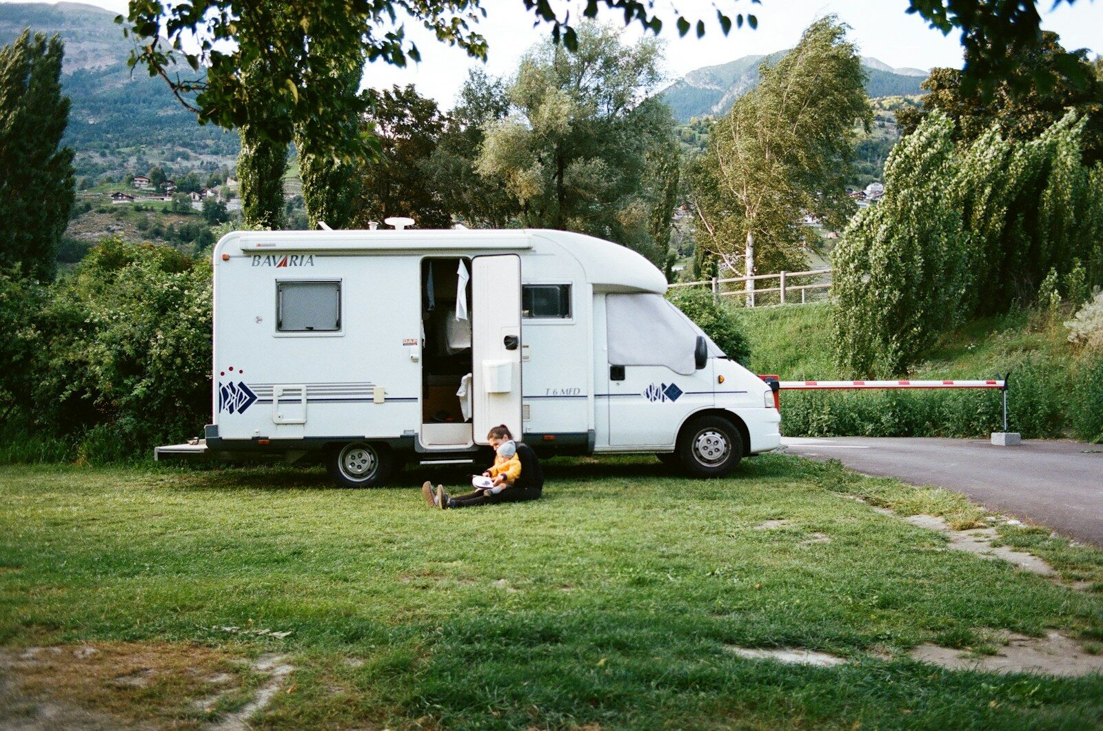 Photo by lucas Favre white rv trailer on green grass field during daytime