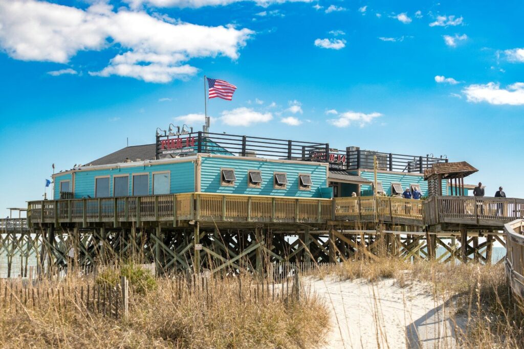 Myrtle Beach Pier - A Must-Visit Destination for Beach Lovers 11 a blue house sitting on top of a wooden pier